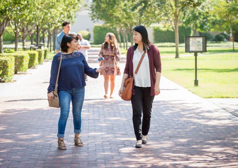 graduate students walk on campus